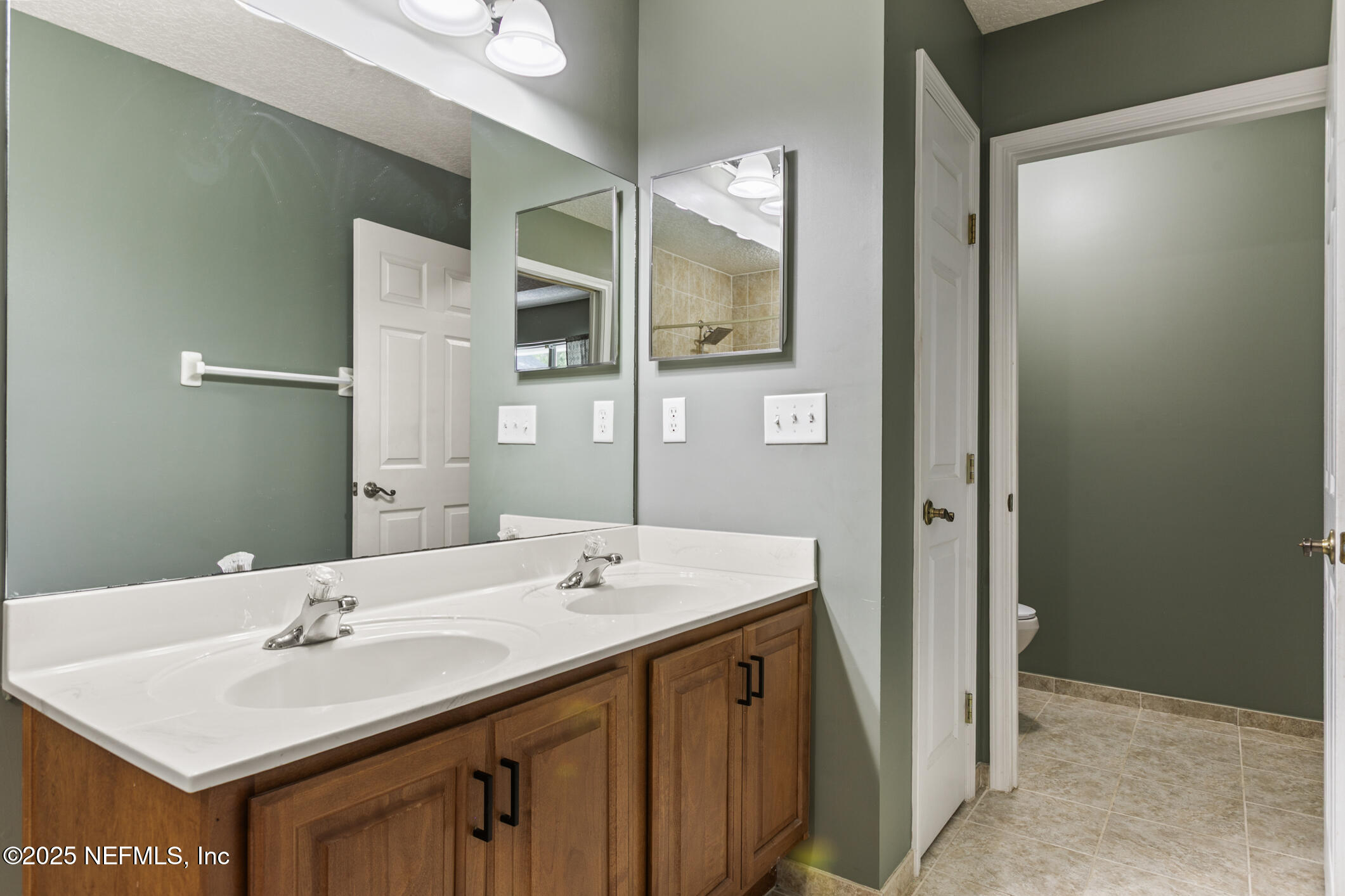 85 Murray Street North Baldwin, FL 32234 - Photo 27 of 49 a bathroom with a sink and a mirror