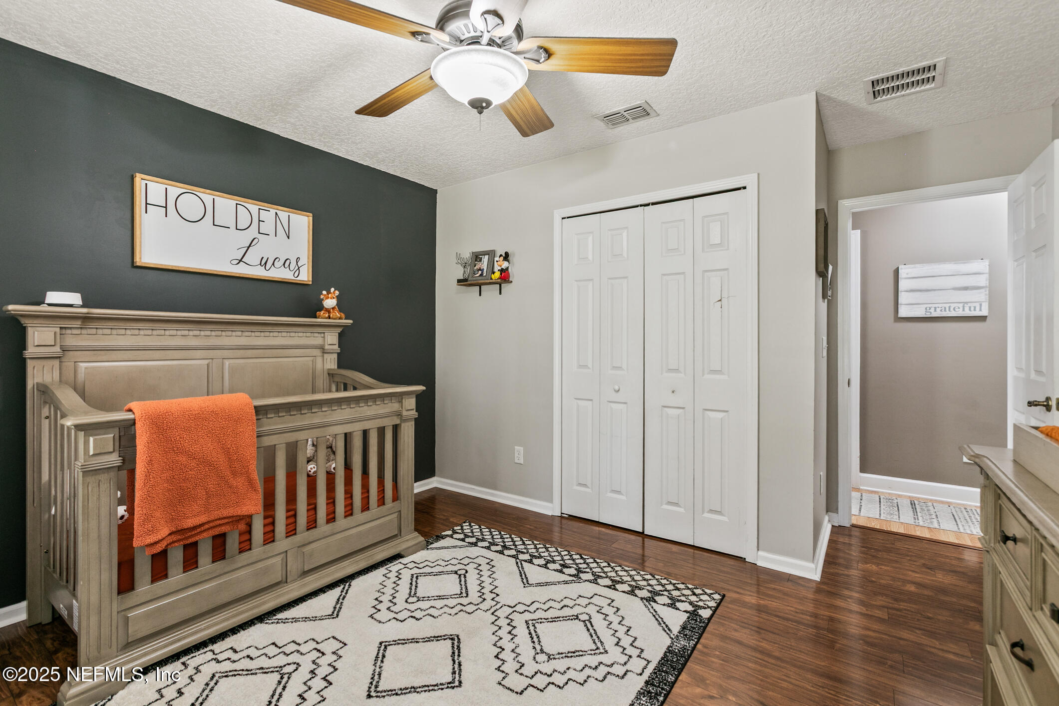 85 Murray Street North Baldwin, FL 32234 - Photo 29 of 49 a view of an empty room wooden floor and fan