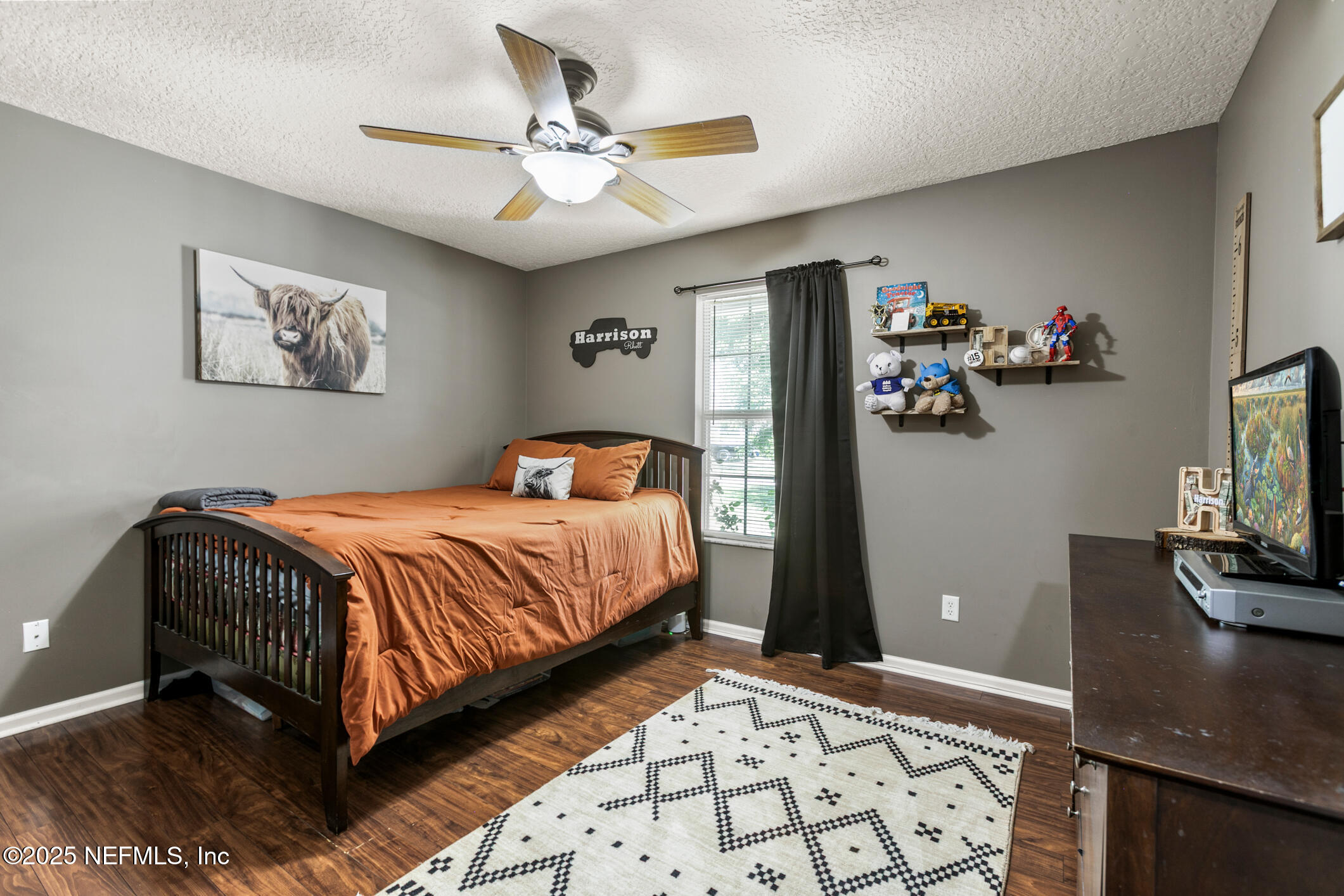 85 Murray Street North Baldwin, FL 32234 - Photo 31 of 49 a bedroom with a bed and a flat screen tv