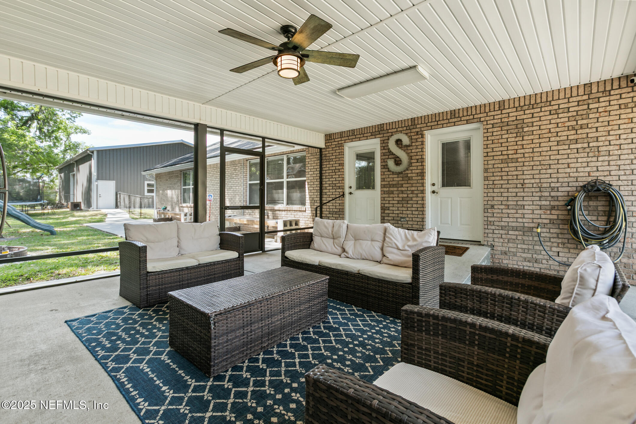 85 Murray Street North Baldwin, FL 32234 - Photo 38 of 49 a living room with furniture and a floor to ceiling window