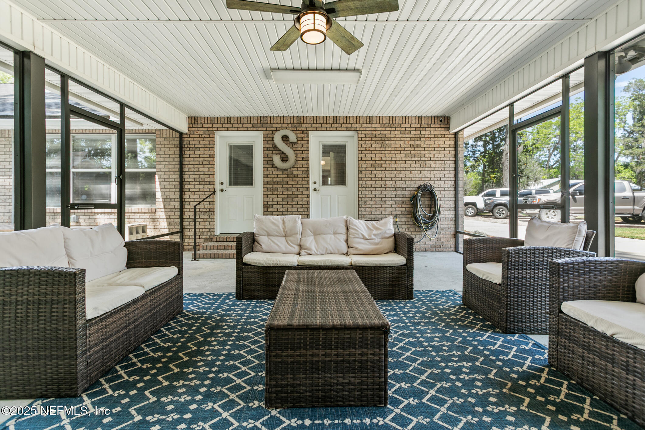85 Murray Street North Baldwin, FL 32234 - Photo 41 of 49 a living room with furniture a rug and a chandelier