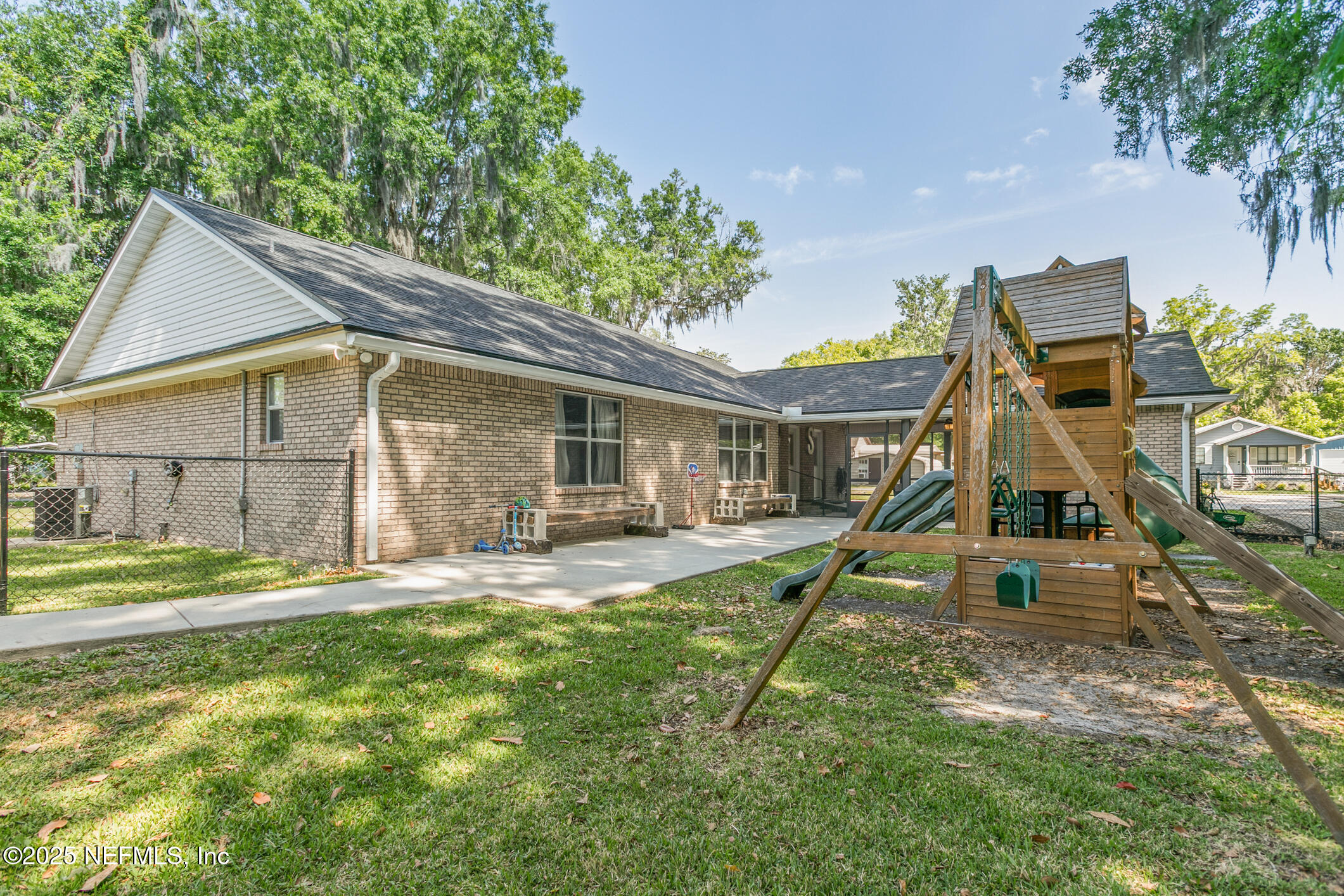 85 Murray Street North Baldwin, FL 32234 - Photo 44 of 49 a house that has a big wooden fence and a table and chairs