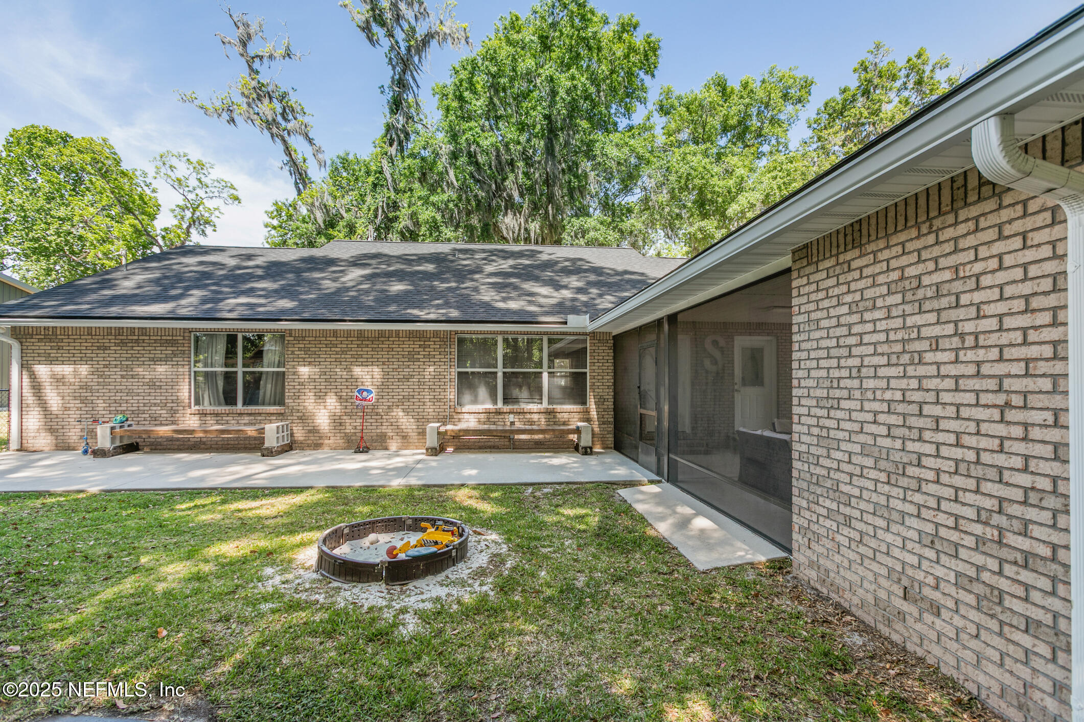 85 Murray Street North Baldwin, FL 32234 - Photo 46 of 49 a backyard of a house with yard table and chairs