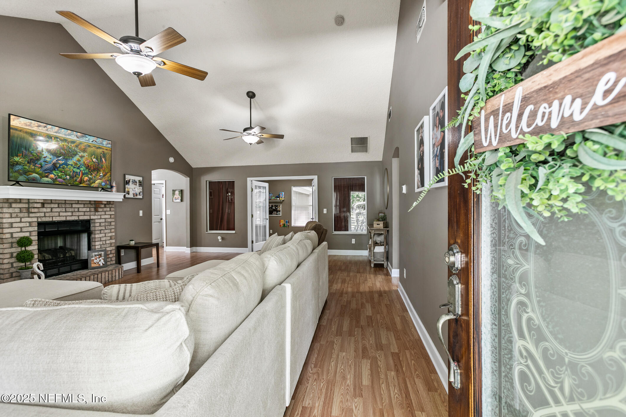 85 Murray Street North Baldwin, FL 32234 - Photo 7 of 49 a view of a livingroom with furniture a fireplace chandeliers fan