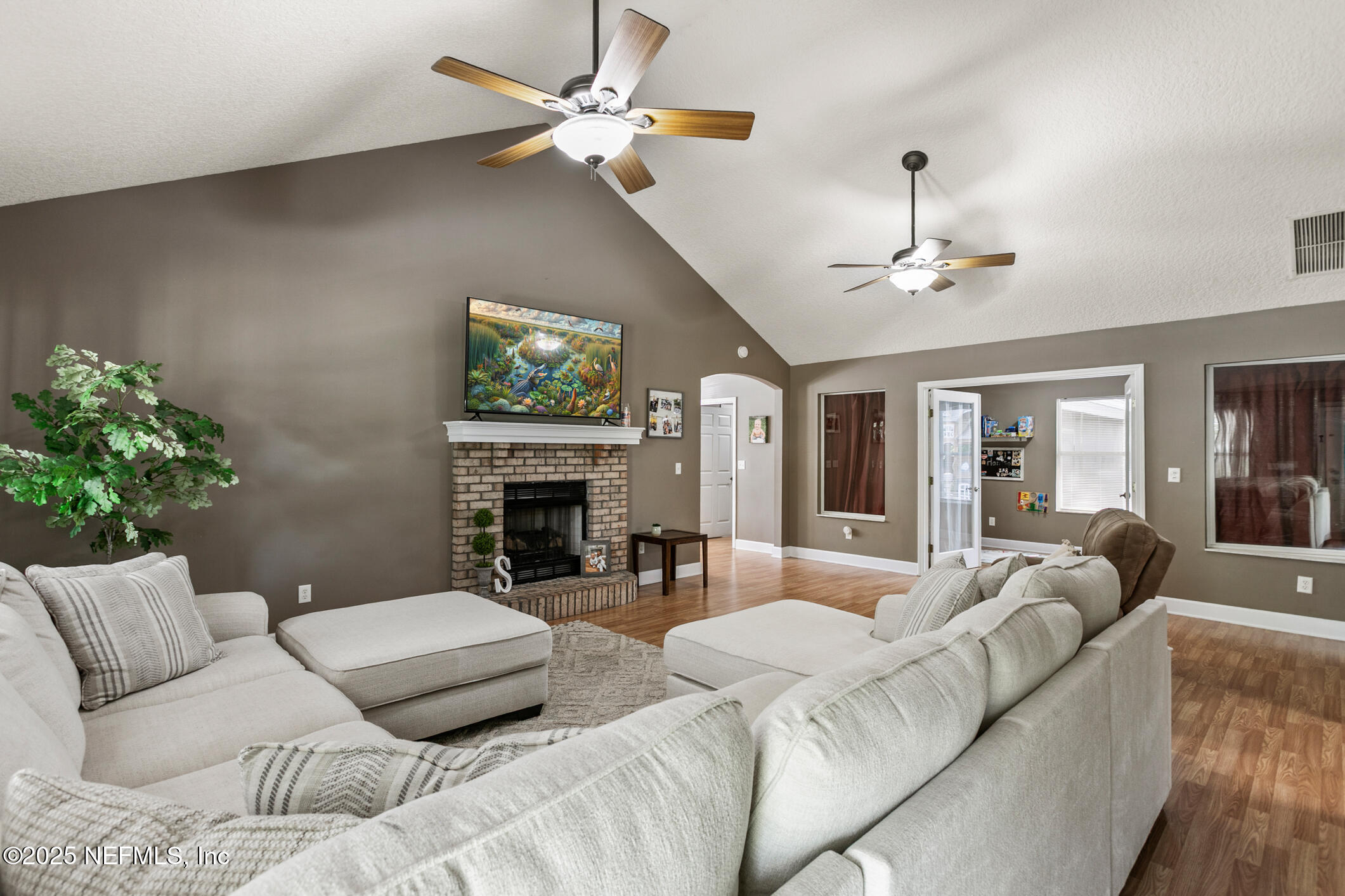 85 Murray Street North Baldwin, FL 32234 - Photo 10 of 49 a living room with furniture a fireplace and a chandelier