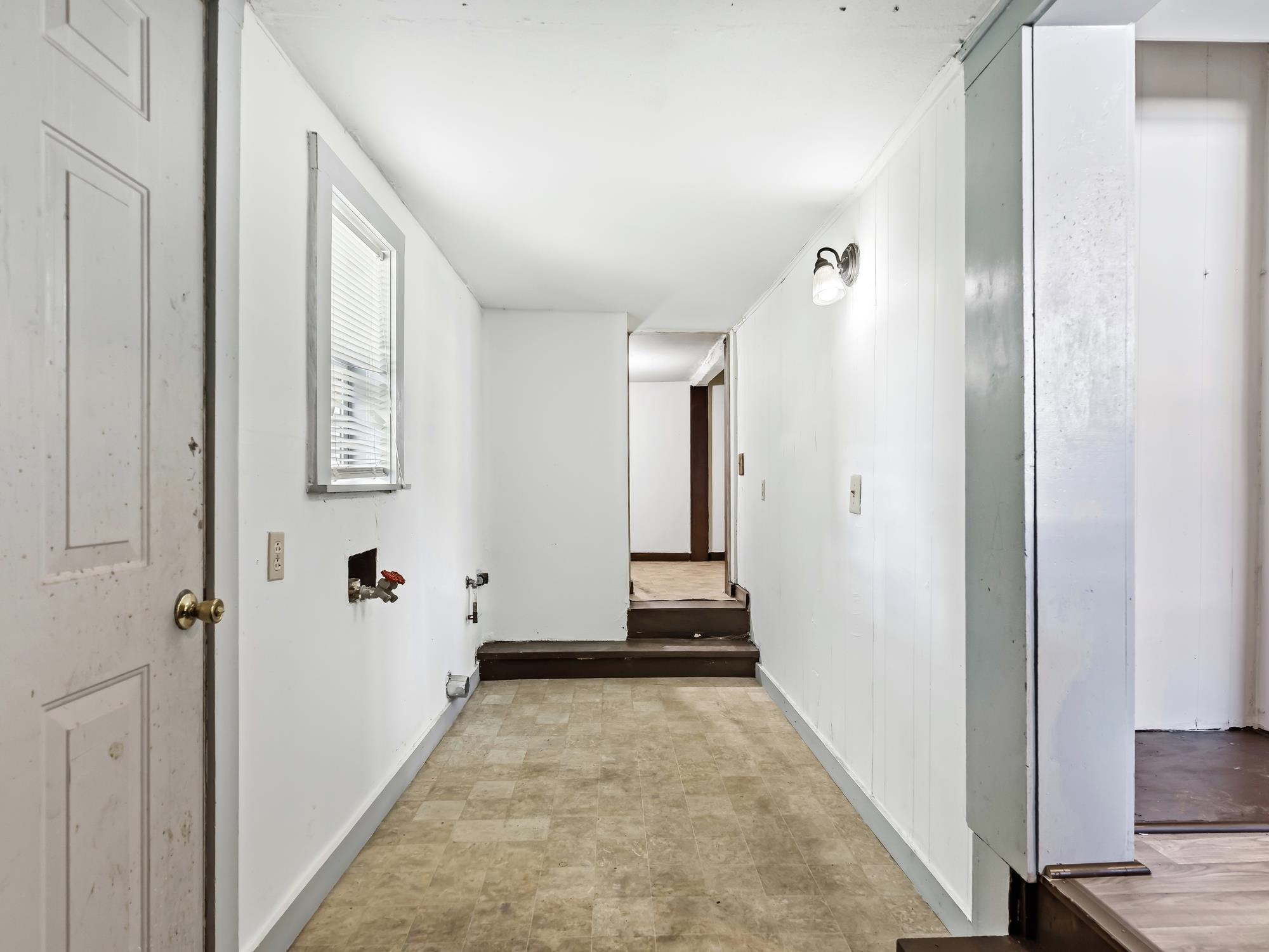 737 9th Street Port Arthur, TX 77640 - Photo 17 of 20 a view of a hallway with wooden floor and staircase