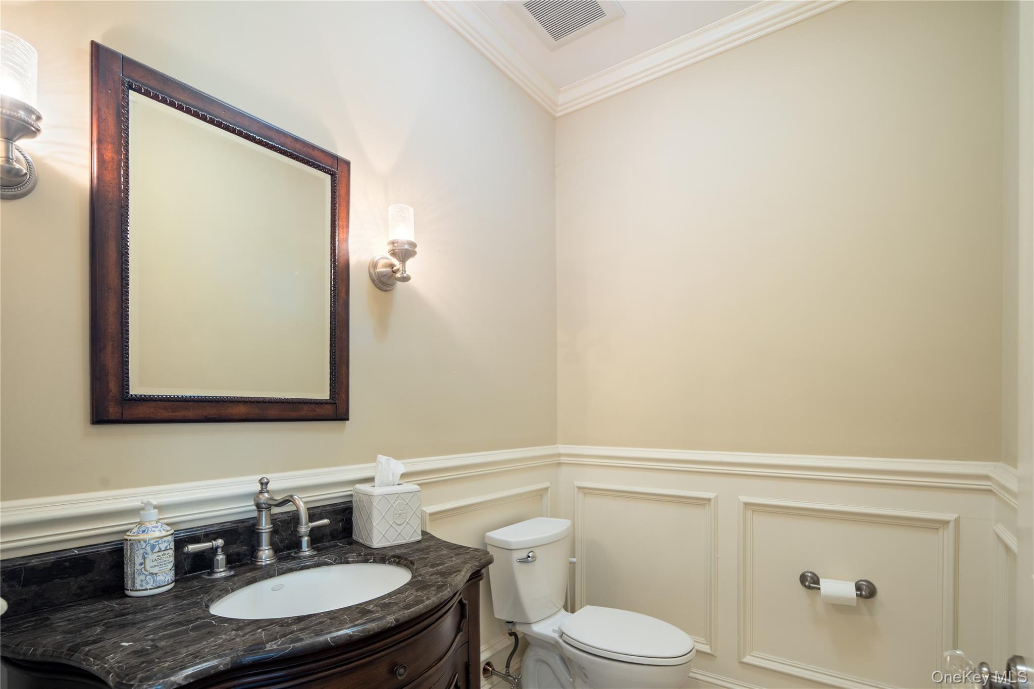 77 Byram Ridge Road Armonk, NY 10504 - Photo 24 of 48 Main floor powder room, marble topped vanity, wainscot wall panels, wall sconces, crown molding