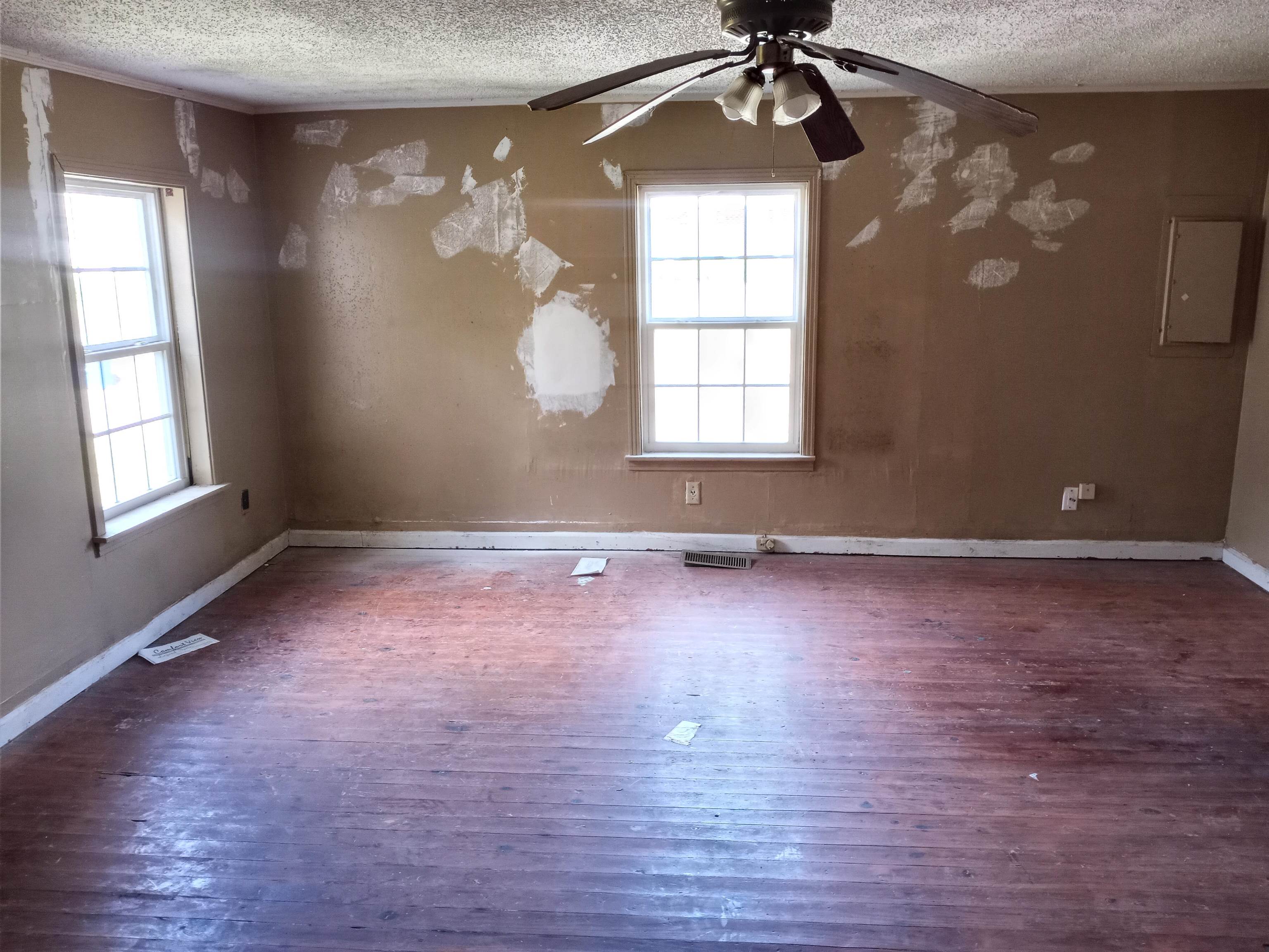 417 West Ripley Avenue Covington, TN 38019 - Photo 6 of 7 an empty room with wooden floor chandelier and windows