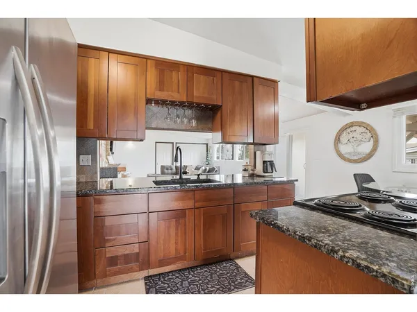a kitchen with stainless steel appliances granite countertop a sink stove and refrigerator
