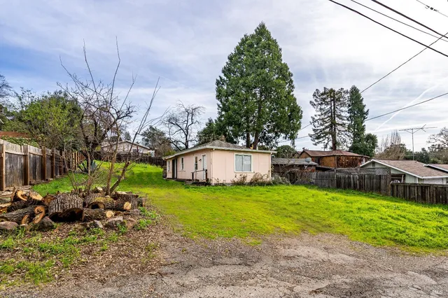 a view of a house with backyard and sitting area