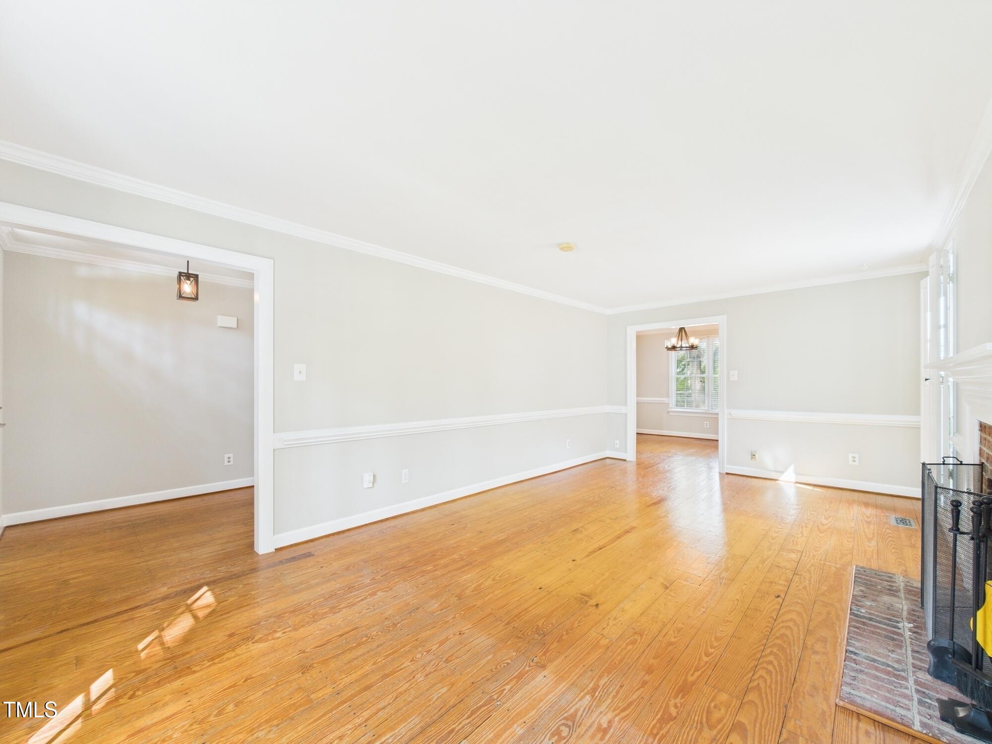 7117 Sandringham Drive Raleigh, NC 27613 - Photo 13 of 54 a view of empty room with wooden floor and fan