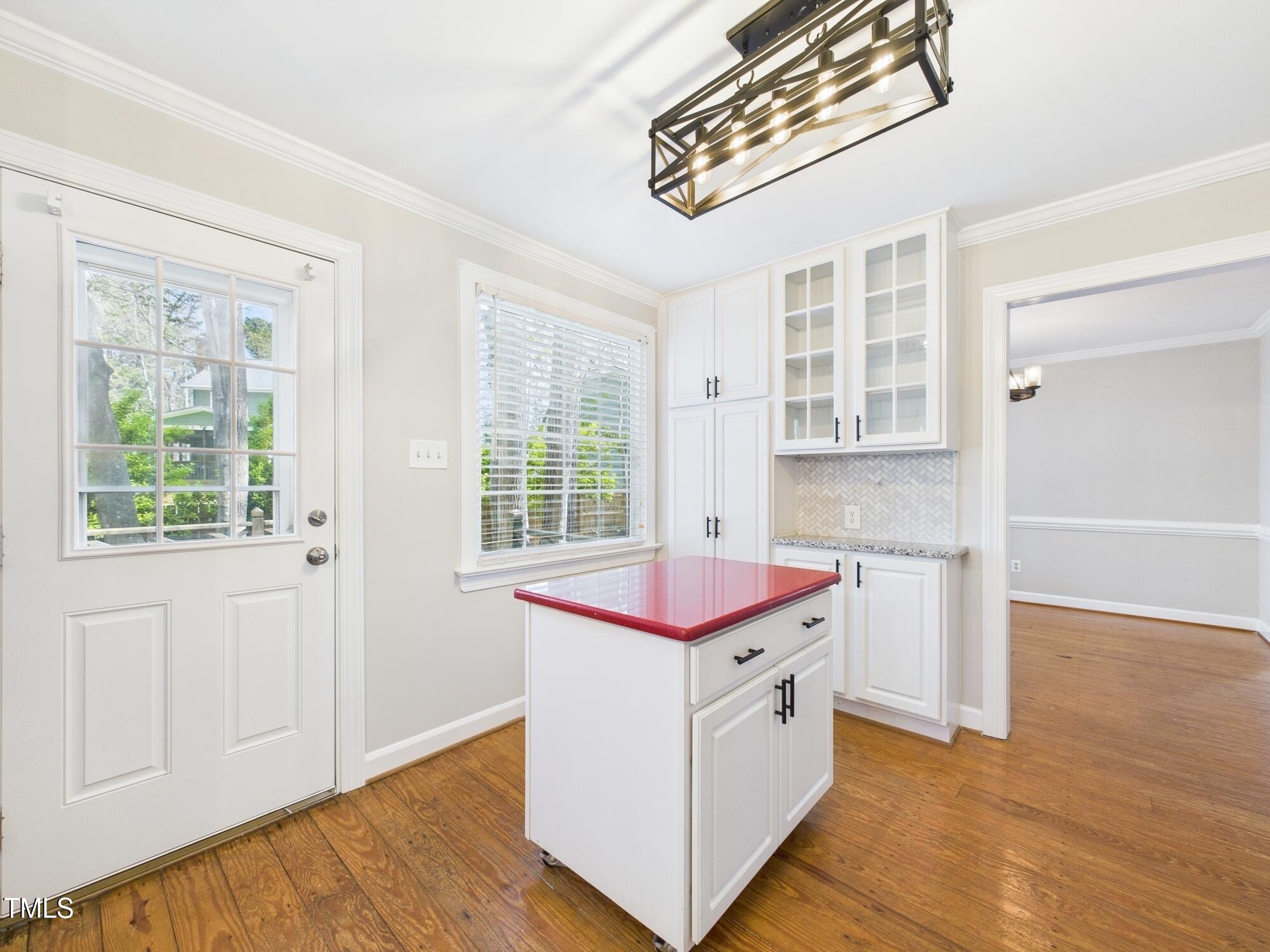 7117 Sandringham Drive Raleigh, NC 27613 - Photo 23 of 54 a kitchen that has a lot of cabinets in it