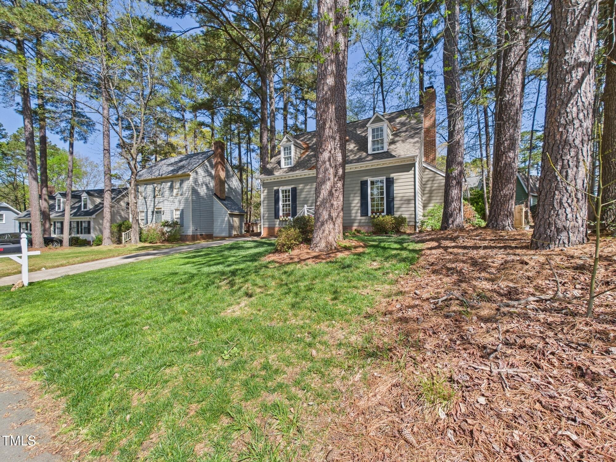 7117 Sandringham Drive Raleigh, NC 27613 - Photo 5 of 54 a large building with trees in front of it