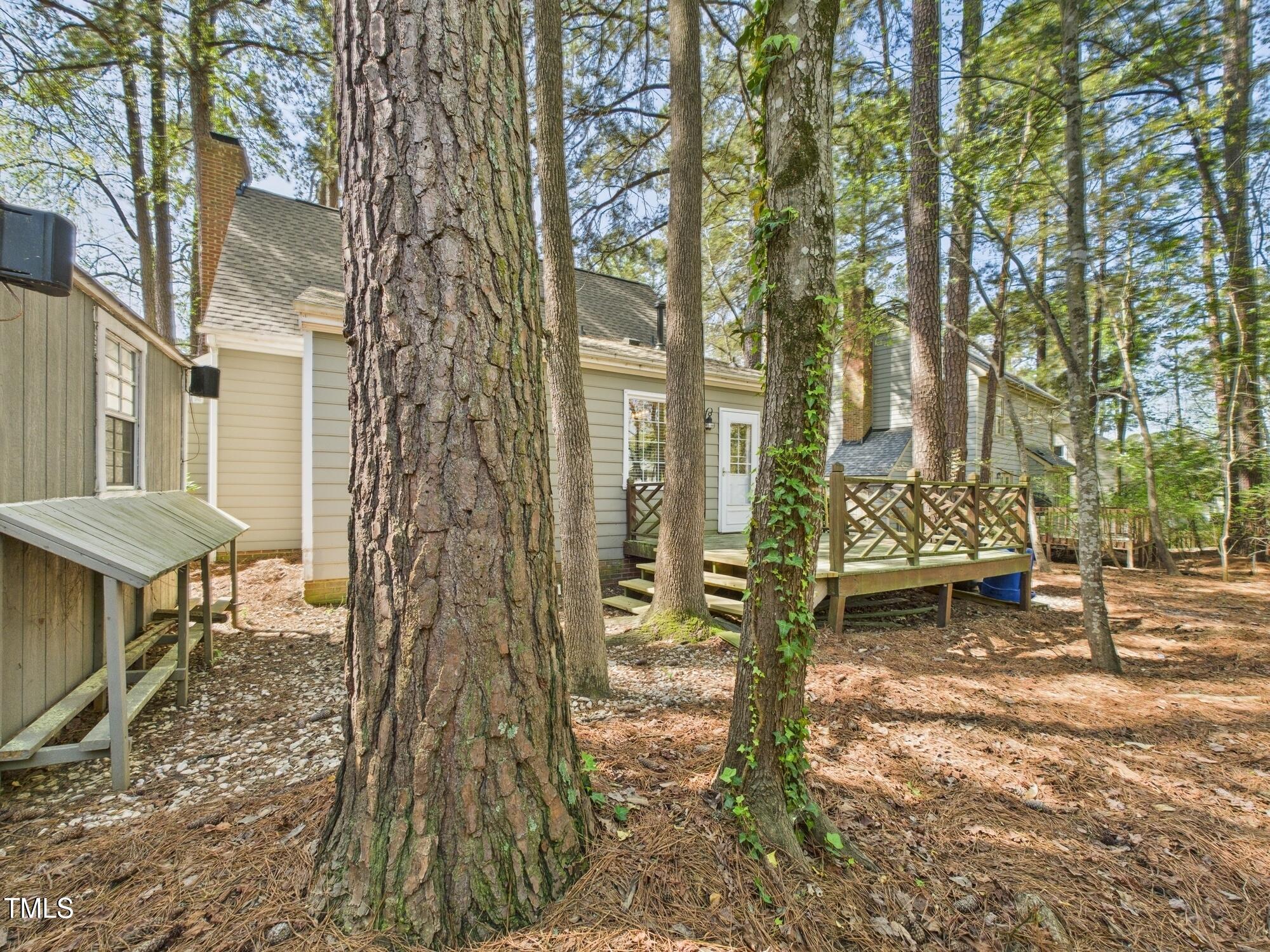 7117 Sandringham Drive Raleigh, NC 27613 - Photo 54 of 54 a backyard of a house with table and chairs