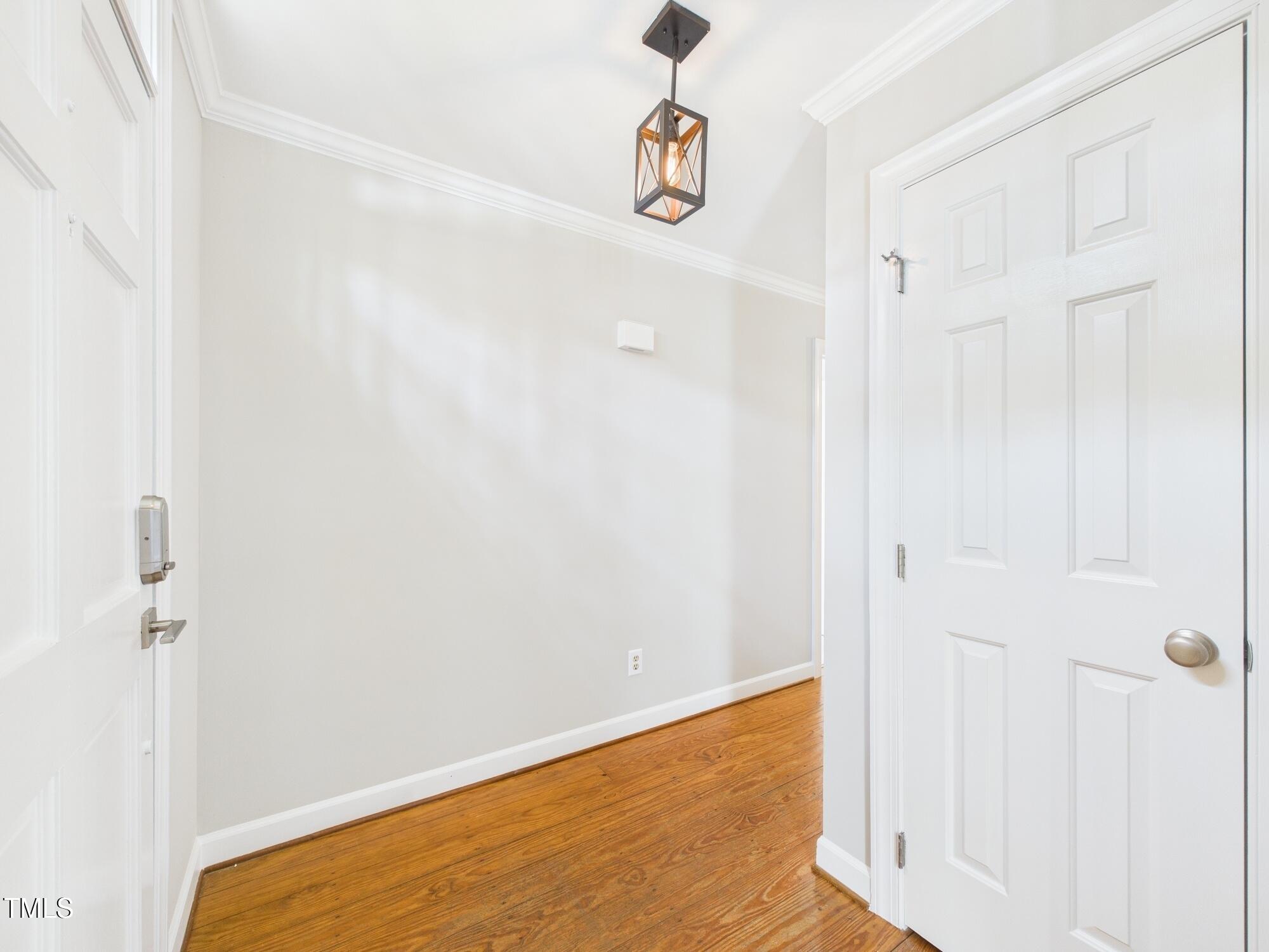 7117 Sandringham Drive Raleigh, NC 27613 - Photo 9 of 54 a view of a livingroom with wooden floor