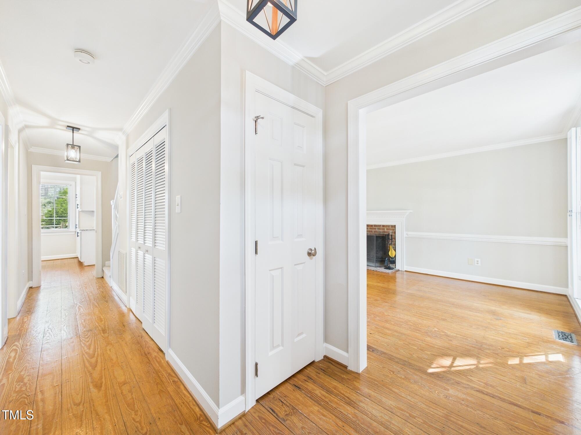 7117 Sandringham Drive Raleigh, NC 27613 - Photo 10 of 54 a view of a hallway with wooden floor and closet area