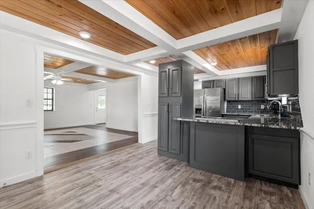 a view of a kitchen with a sink and cabinets