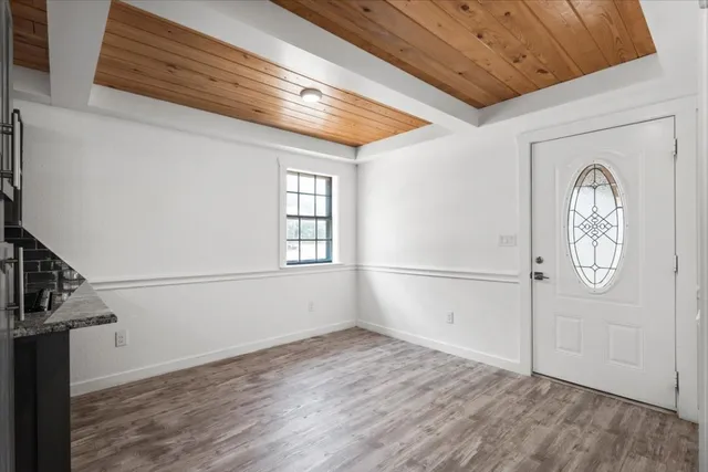 a view of a hallway with wooden floor and entryway