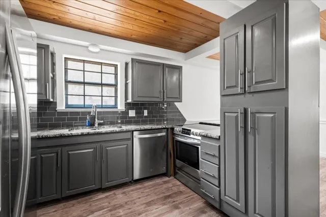 a kitchen with stainless steel appliances granite countertop a stove and a sink