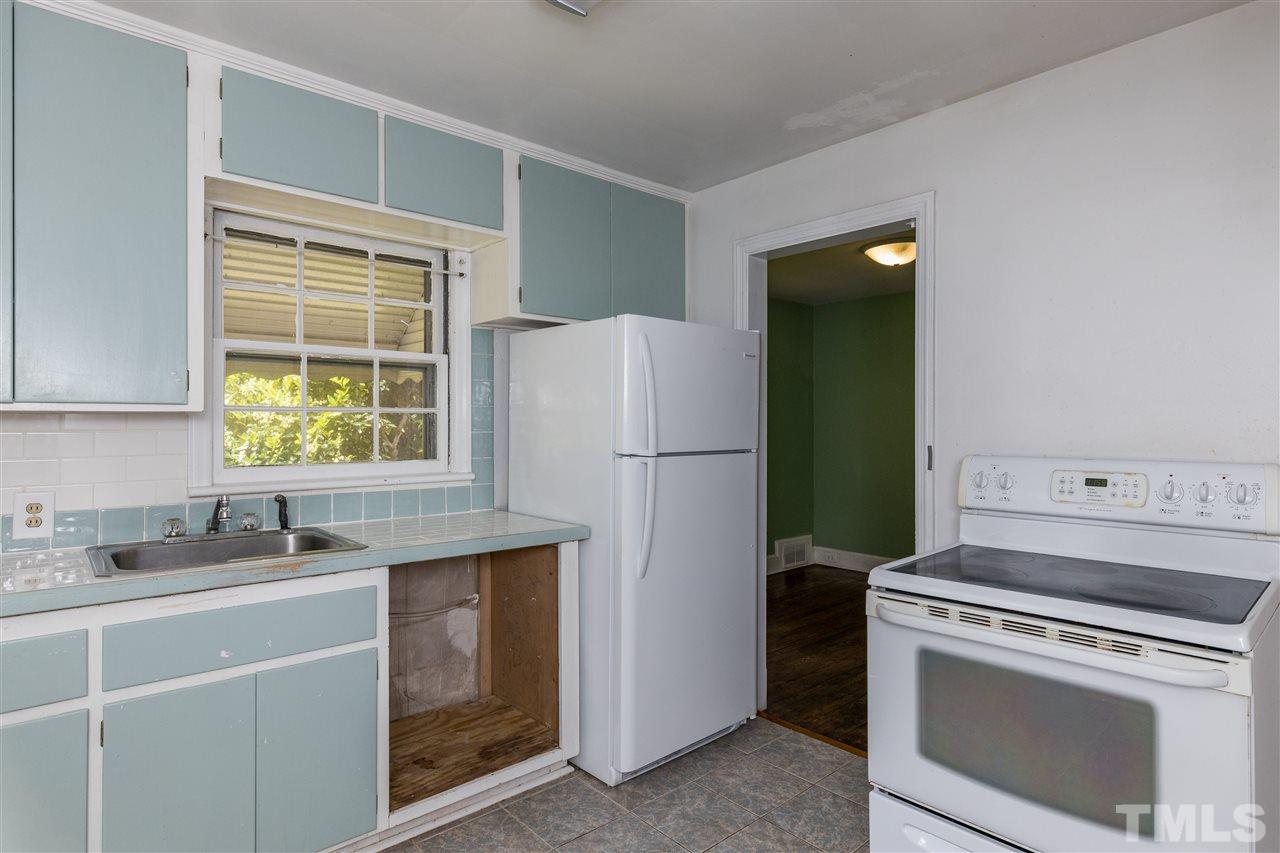 614 Elm Street Raleigh, NC 27604 - Photo 16 of 30 a kitchen with a refrigerator stove and sink