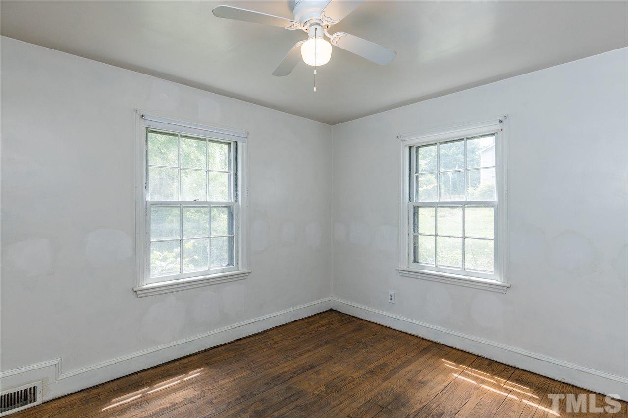 614 Elm Street Raleigh, NC 27604 - Photo 21 of 30 an empty room with wooden floor ceiling fan and windows