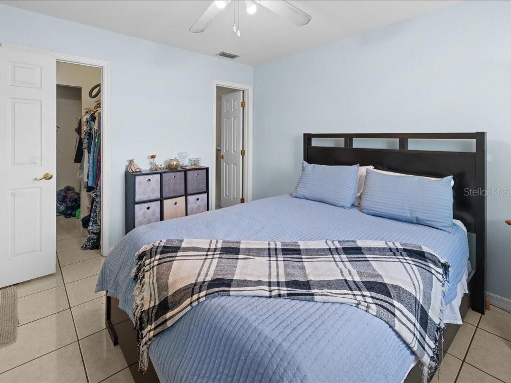 25275 Rampart Boulevard, Unit 1607 Punta Gorda, FL 33983 - Photo 14 of 23 a bedroom with a bed and wooden floor