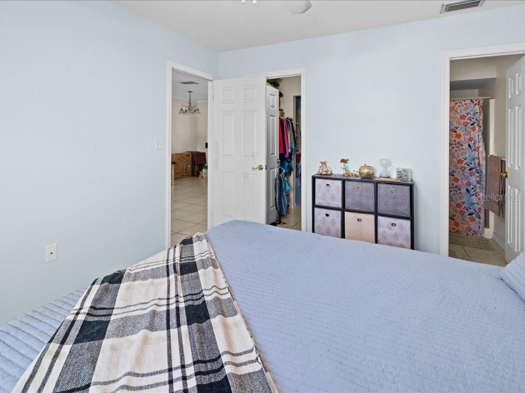 25275 Rampart Boulevard, Unit 1607 Punta Gorda, FL 33983 - Photo 15 of 23 a bedroom with a bed and a wooden floor