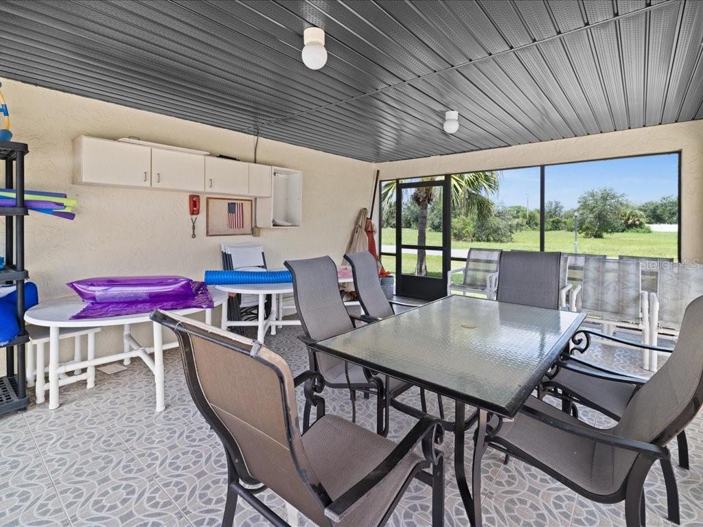 25275 Rampart Boulevard, Unit 1607 Punta Gorda, FL 33983 - Photo 23 of 23 a dining room with furniture and a floor to ceiling window