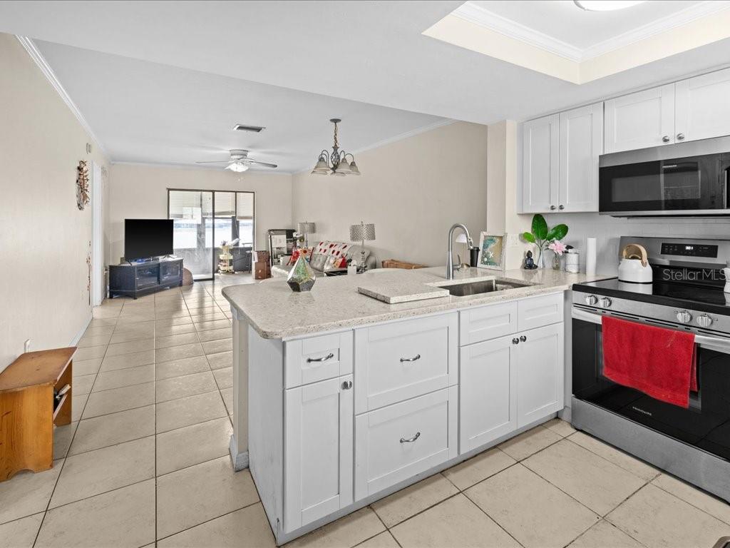 25275 Rampart Boulevard, Unit 1607 Punta Gorda, FL 33983 - Photo 4 of 23 a kitchen with a sink and cabinets