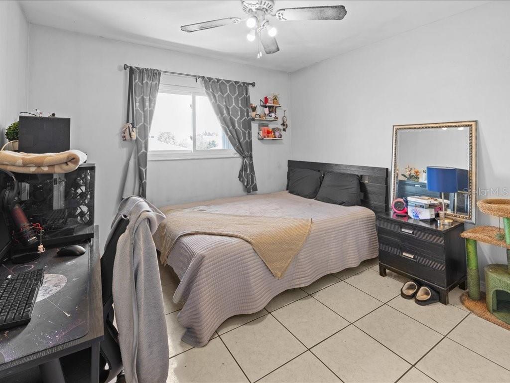 25275 Rampart Boulevard, Unit 1607 Punta Gorda, FL 33983 - Photo 9 of 23 a bedroom with a bed and a chandelier