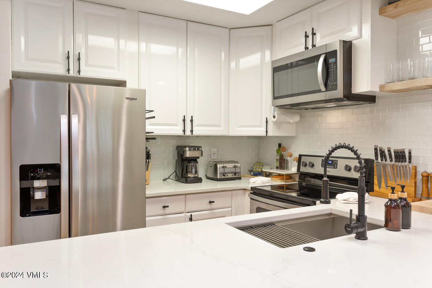1650 Fall Ridge Road, Unit 401 Vail, CO 81657 - Photo 11 of 29 a kitchen with stainless steel appliances granite countertop a refrigerator and a sink