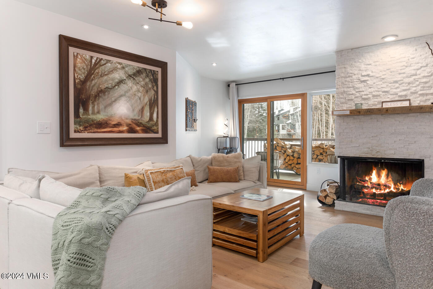 1650 Fall Ridge Road, Unit 401 Vail, CO 81657 - Photo 2 of 29 a living room with furniture a fireplace and a flat screen tv