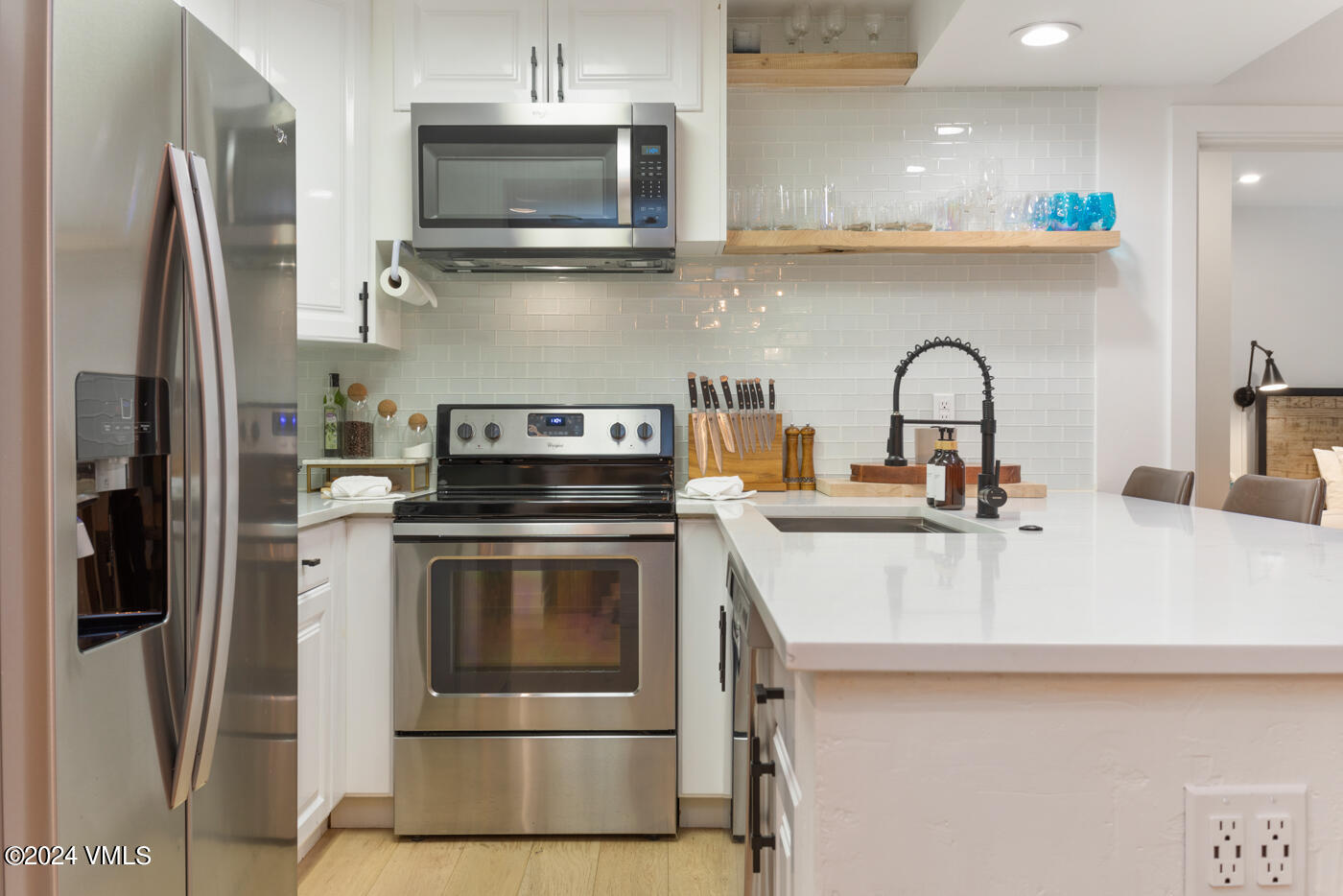 1650 Fall Ridge Road, Unit 401 Vail, CO 81657 - Photo 10 of 29 a kitchen with stainless steel appliances a sink a stove and a refrigerator