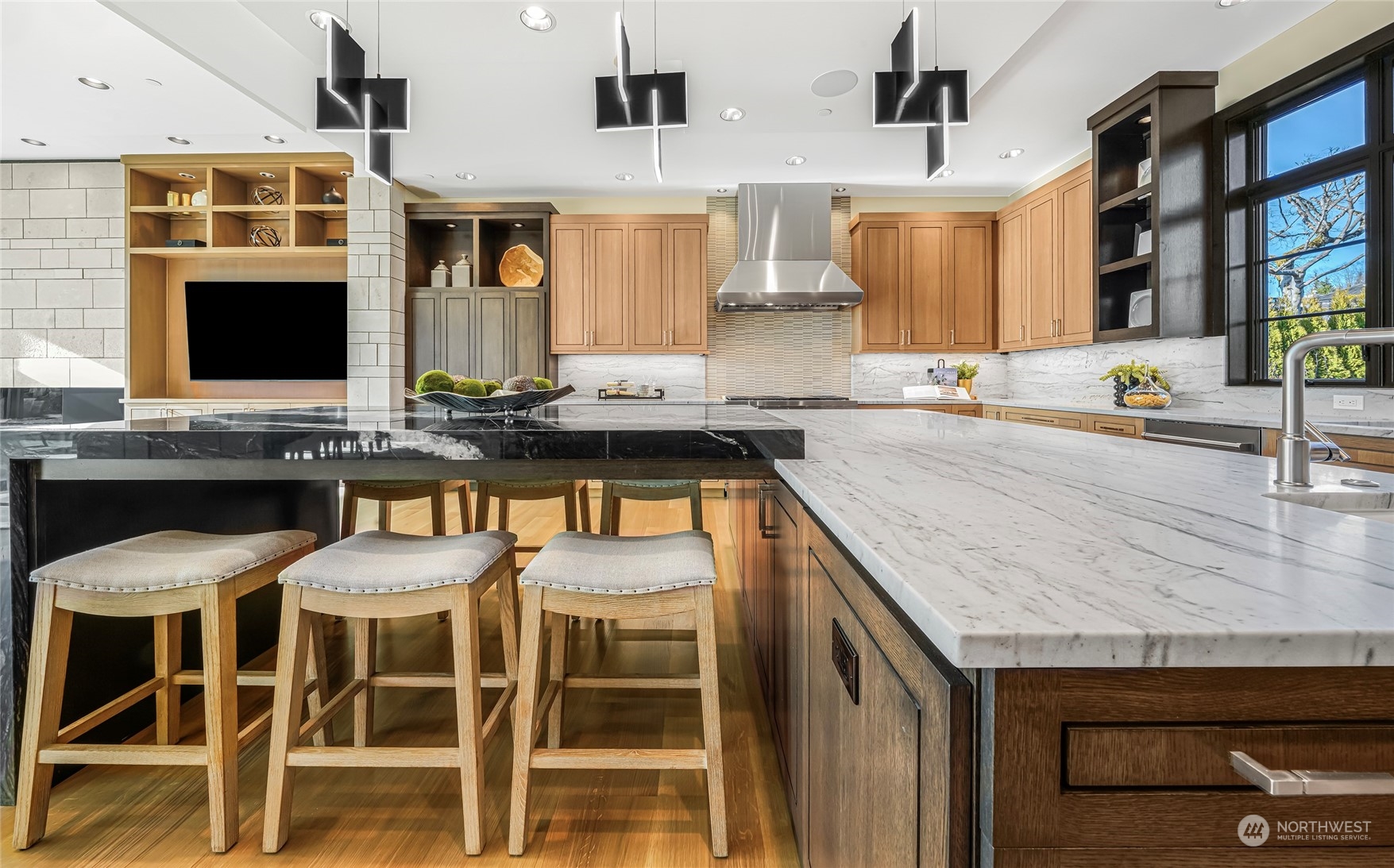 8467 Midland Road Medina, WA 98039 - Photo 21 of 40 a kitchen with a sink stools a counter space and cabinets