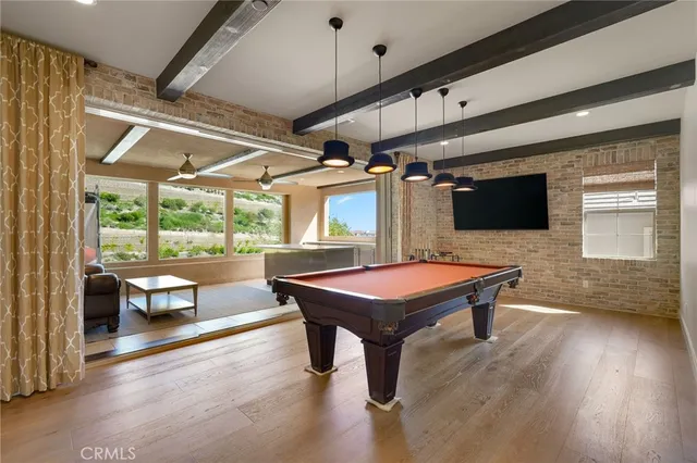 a living room with furniture a fireplace and a chandelier