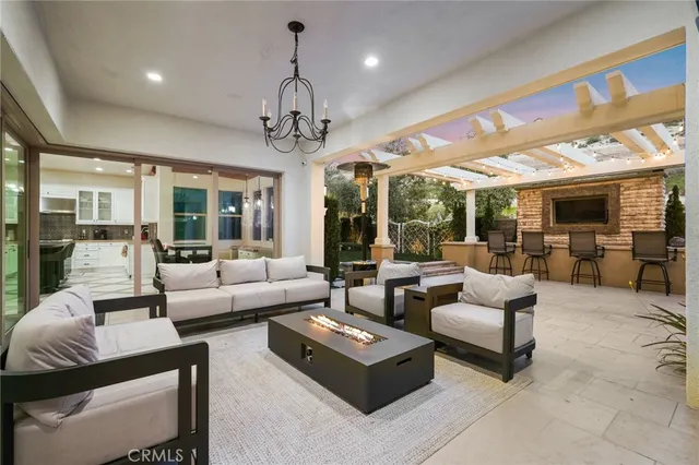 a living room with furniture a chandelier and a fireplace