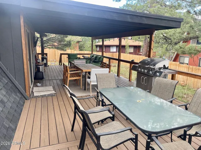 a view of a patio with table and chairs