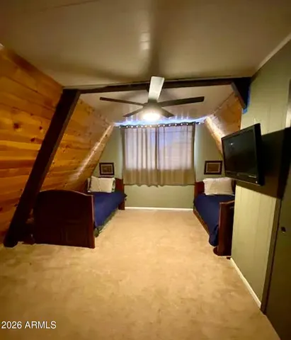 a room with a bed and a television