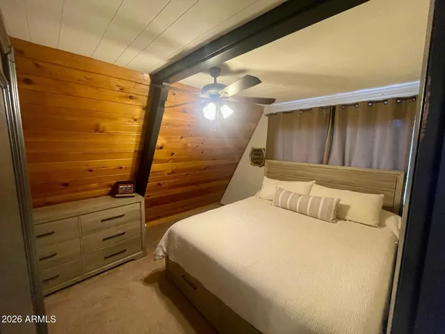 a bed room with a bed and a mirror