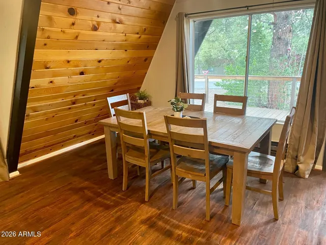 a view of a dining hall with furniture and wooden floor