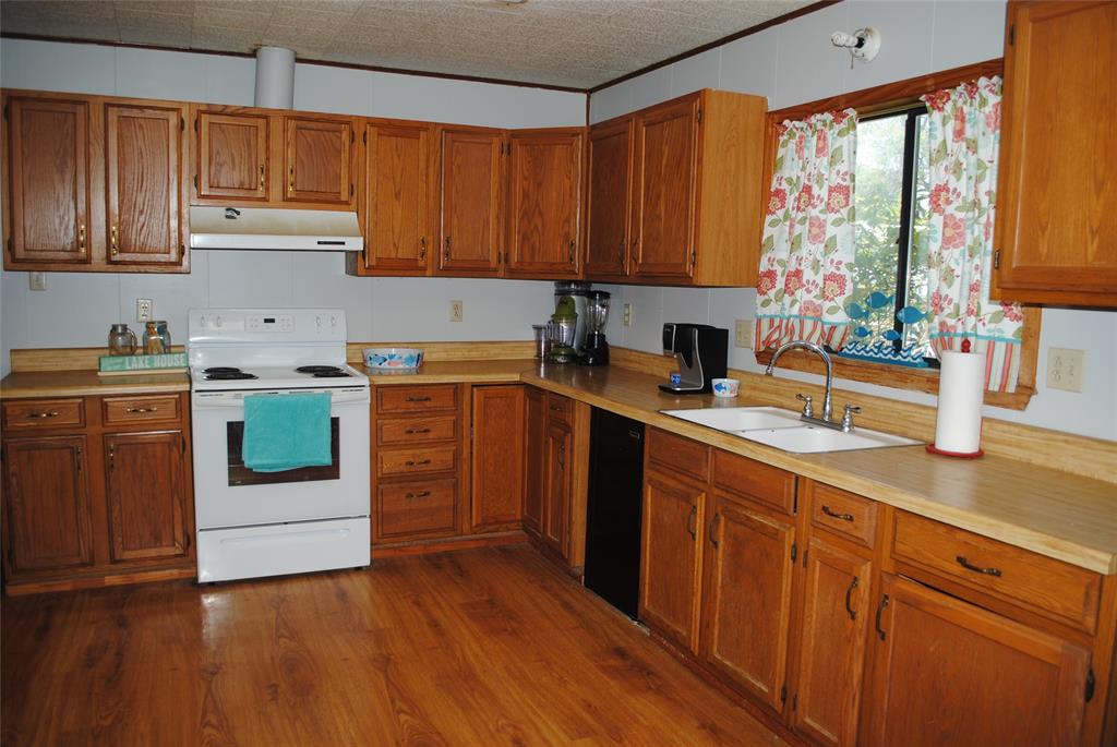 73-109 109th Goldthwaite, TX 76844 - Photo 18 of 37 a kitchen with a sink stove and cabinets