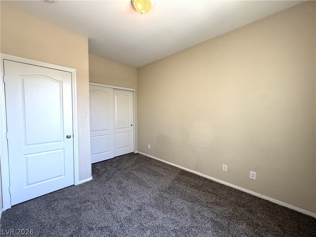 5942 Rampolla Drive Las Vegas, NV 89141 - Photo 24 of 27 A well-lit bedroom provides comfortable living with soft carpet flooring and convenient closet access.