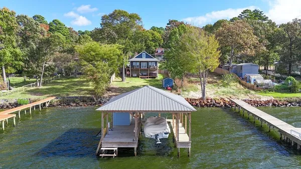 a aerial view of a house with swimming pool having outdoor seating