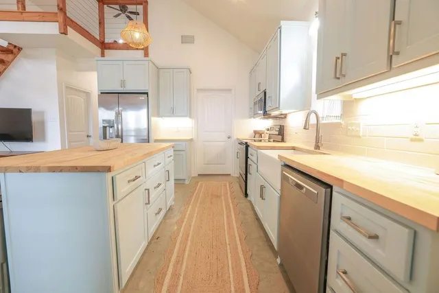a bedroom with a white bed and white walls