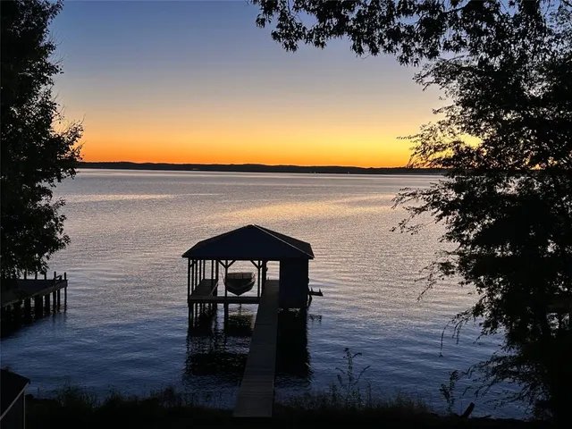 an aerial view of a house with a yard and lake view