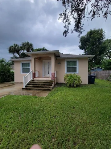 a front view of house with yard and trees
