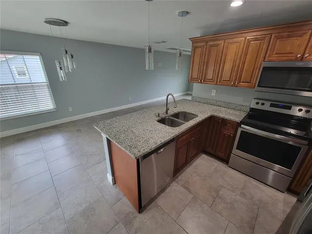 a kitchen with granite countertop a sink and a stove