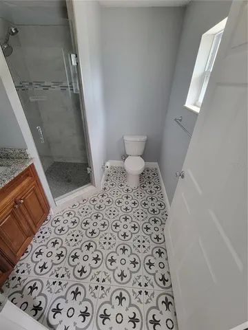 a bedroom with a bed and a rug