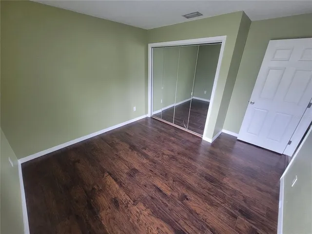 an empty room with wooden floor