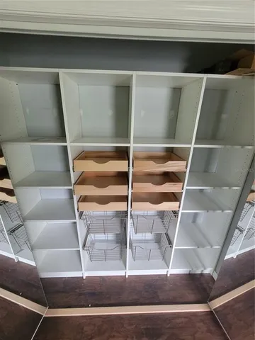 a view of room with wooden floor and windows